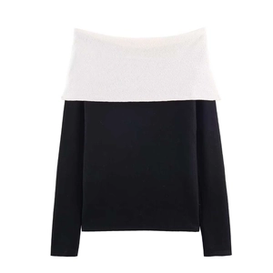 Detailed view of off-the-shoulder knit sweater with contrast white bow collar
