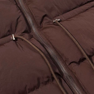 Close-up of quilted winter puffer jacket with metal zipper and adjustable drawstrings