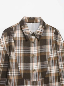 Detail of classic brown plaid shirt showing collar, buttons and size M label