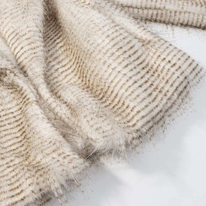 Macro detail of high-quality striped faux fur texture in beige and cream colors