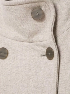 Close-up of beige wool blend coat with twill texture and marble pattern buttons