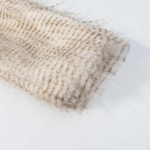 Macro detail of plush faux fur texture with apricot and brown stripes for winter coats