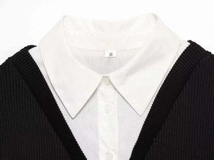 Detail of the white poplin collar and V-neck ribbed knit texture of the mini dress