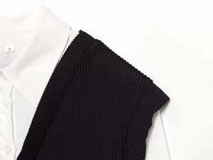 Detail of white cotton poplin collar under black striped knit vest showing size S label