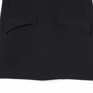 Chic black dress with puff sleeves and textured fabric featuring dual pocket details