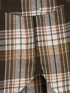 Detailed macro view showing the high-quality invisible zipper on a brown plaid fabric shirt