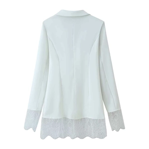 Detail of white blazer back showing princess seams and delicate lace trim on hem