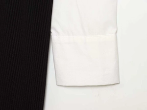 Detail of long sleeve cuff showing black ribbed knit and white poplin fabric contrast