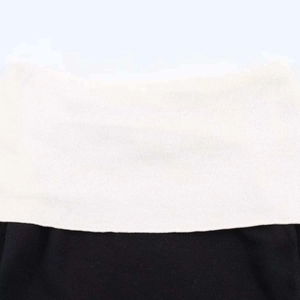 Close-up of black and white contrast knit sweater with elegant off-shoulder fold-over collar