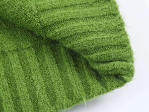 Close-up of grass green ribbed knit fabric featuring soft mohair texture and fibers