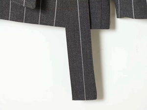 Detailed macro view of dark grey pinstripe fabric and matching waist belt texture
