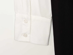 Close-up of white poplin shirt cuffs featuring dual-button closure and fine stitching
