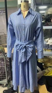 Detailed view of blue striped shirt dress with a waist tie bow and button-down collar