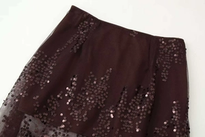 Detail of high waist mesh skirt featuring intricate wave-pattern sequins and embroidery
