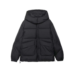 Detail of black hooded puffer jacket with matte nylon fabric and large flap pockets