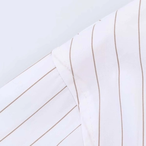 Close-up of fine stitching and brown pinstripe pattern on the white cotton shirt fabric