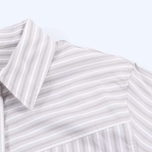 Detailed macro view of the lapel collar and shoulder stitching on a grey striped shirt