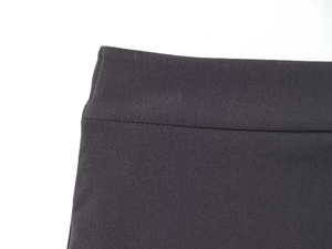 Close-up of the professional stitching and fine textile texture on grey tailored trousers