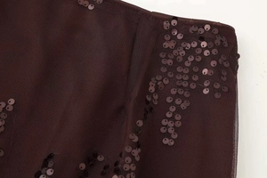 Detailed view of deep chocolate sequins and mesh fabric on high waist skirt