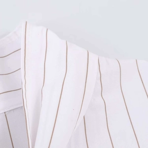 Detail view of white striped shirt showing the collar stitching and fabric texture