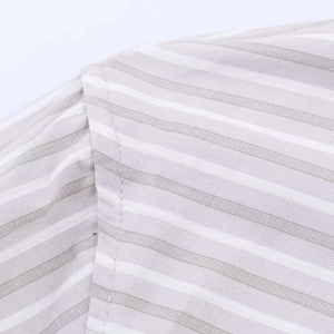 Macro detail of high-quality stitching and gray vertical stripe fabric on the cotton shirt