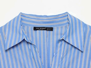 Detail of V-neck collar and blue striped fabric texture with brand size label