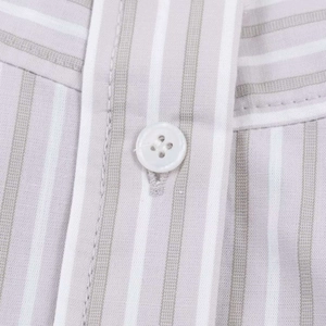 Macro detail of the vertical striped shirt showing fabric texture and white button