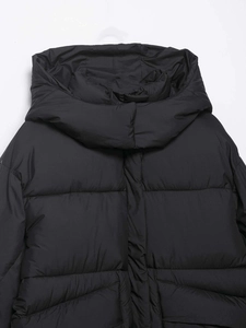 Detail of black hooded puffer jacket with high-density quilting and windproof collar