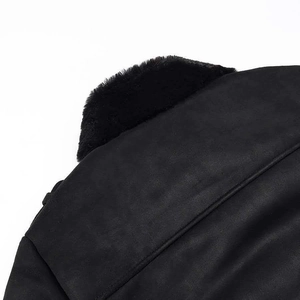 Detail of a black winter jacket featuring premium faux fur collar and suede texture