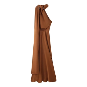 Detail of elegant backless halter neck brown satin maxi dress with flowing neck scarf