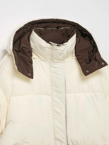 Detail view of the cream white hooded jacket featuring contrasting brown lining and snaps