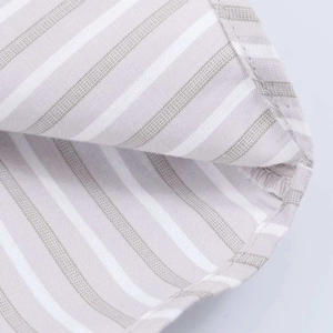 Macro detail of grey and white vertical stripes on a cotton linen shirt with fine stitching