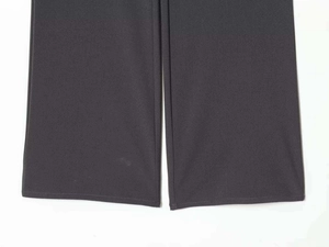 Close-up of charcoal grey trouser hem showing high-quality stitching and fabric texture