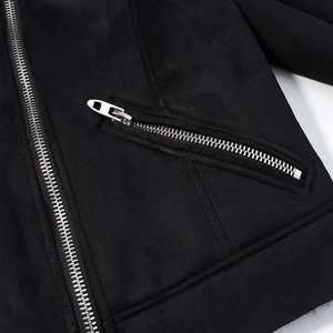 Detail of a black faux suede jacket featuring high-quality silver metal zippers and seams