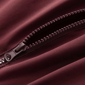 Deep red slim fit ski jumpsuit with high-quality metal zipper and smooth fabric detail