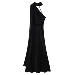 Detail of elegant black backless maxi dress with draped ribbon and silky satin texture