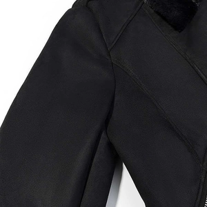 Detail of black faux suede jacket featuring warm plush lining and fine stitching work