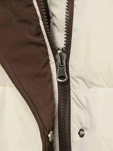 Close-up of contrast stitching, silver metal zipper, and snap button on the hooded jacket