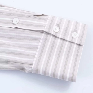 Detail of grey and white vertical striped shirt cuff with high-quality white buttons