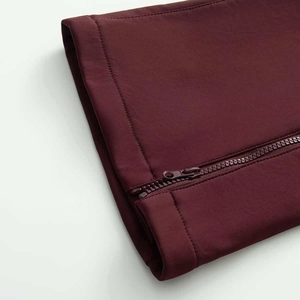 Close-up of wine red ski jumpsuit featuring a high-quality zipper and elastic fabric