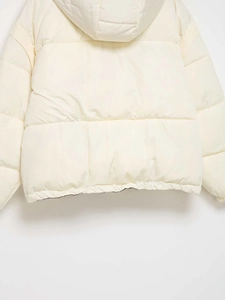 Detail view of back side of cream-colored hooded padded jacket with quilted texture