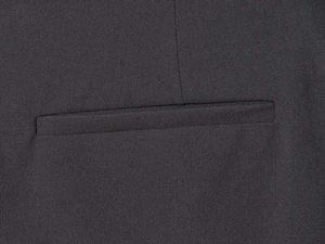Close-up of high-density fabric texture and neat welt pocket on dark formal trousers
