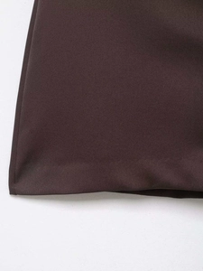 Detailed view of the neat hemline stitching on this high-waisted dark brown mini skirt