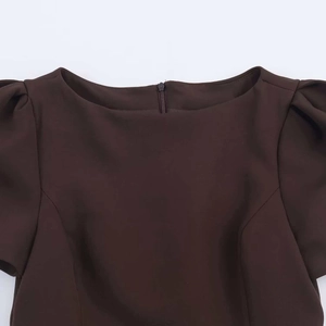 Detail of a brown short sleeve dress featuring a round neck and invisible back zipper