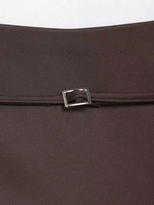 Detail of dark brown high waist mini skirt featuring a silver rectangular metal buckle