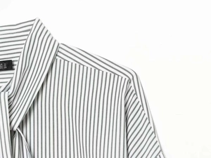 Detailed close-up of a striped shirt neckline with size label S on white background