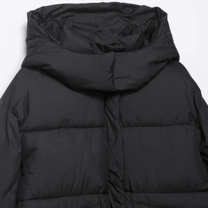 Women's minimalist black hooded puffer jacket with loose windproof quilted design