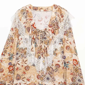 Bohemian floral print dress with white lace stitching and tassel drawstring details