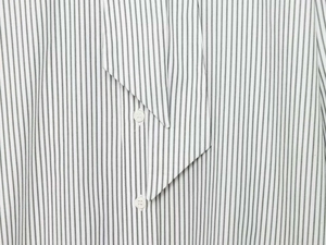 Detail of vertical black and white pinstripe shirt with bow-tie collar and buttons