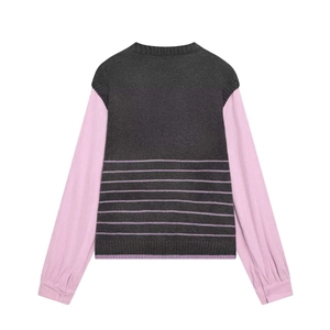 Detail view of pink striped sleeves and dark gray knit vest on back of mixed media top